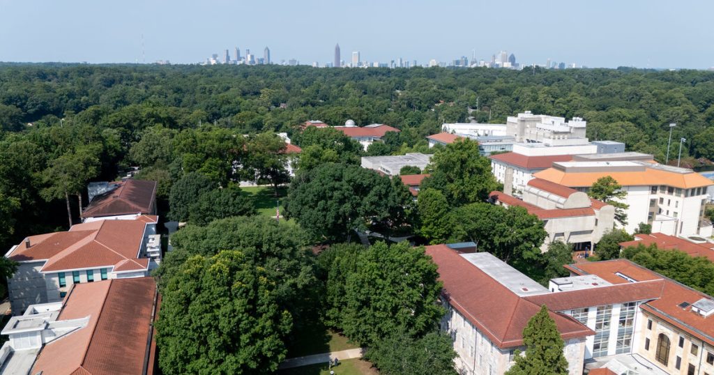 Emory campus buildings amid trees with Atlanta skyline in the distance