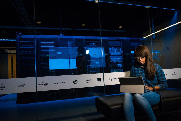 Meta Launches Muse Spark Open AI Model 1 Woman using a laptop in a server room, showcasing modern technology and work environment