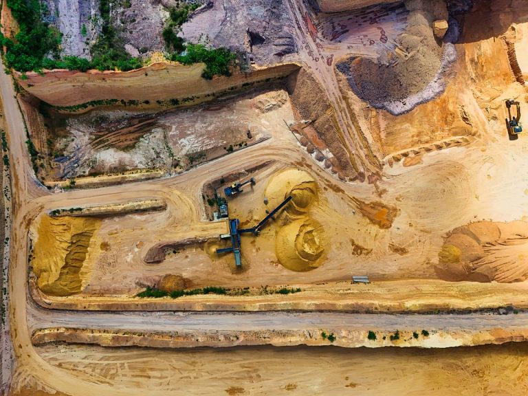 Aerial shot of a quarry with machinery extracting and processing materials