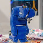 A blue Yaskawa industrial robot arm on display, showcasing advanced technology and robotics