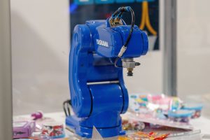 A blue Yaskawa industrial robot arm on display, showcasing advanced technology and robotics